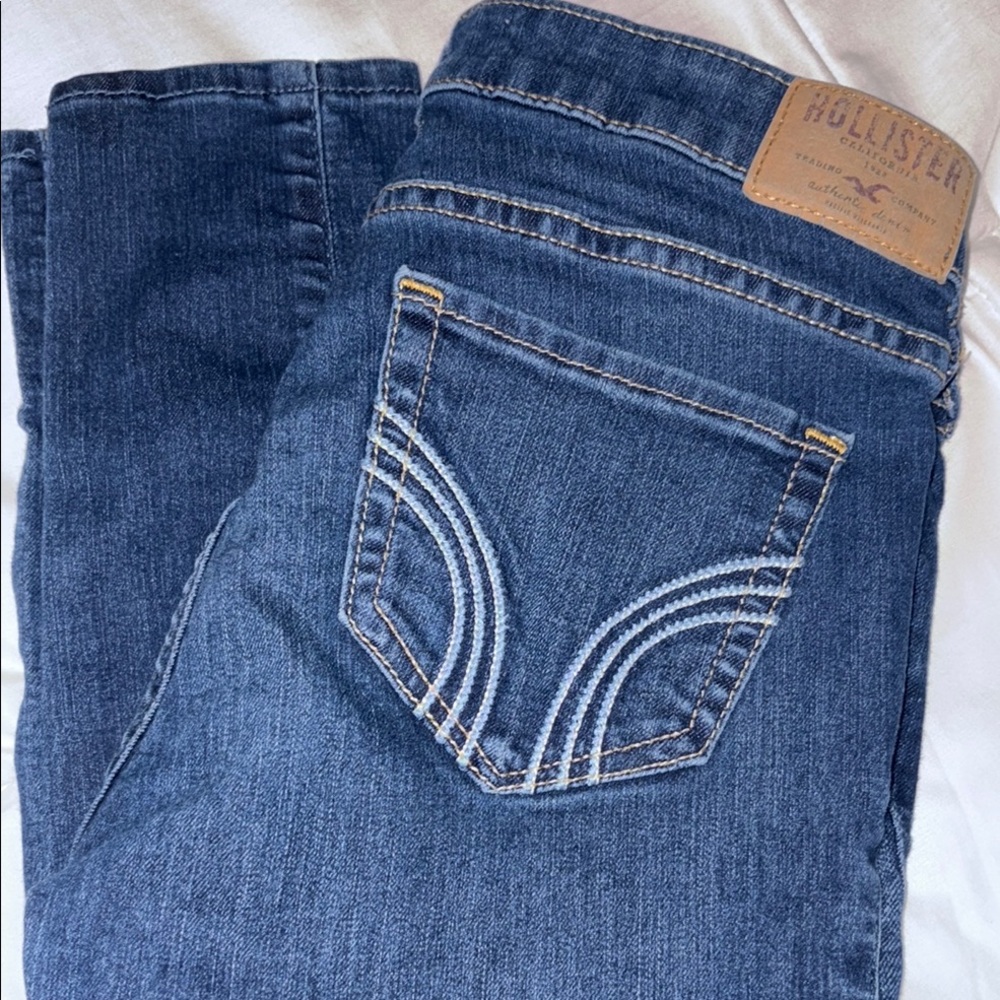 Hollister Blue Jeans with Decorative Stitching and Distressed Look